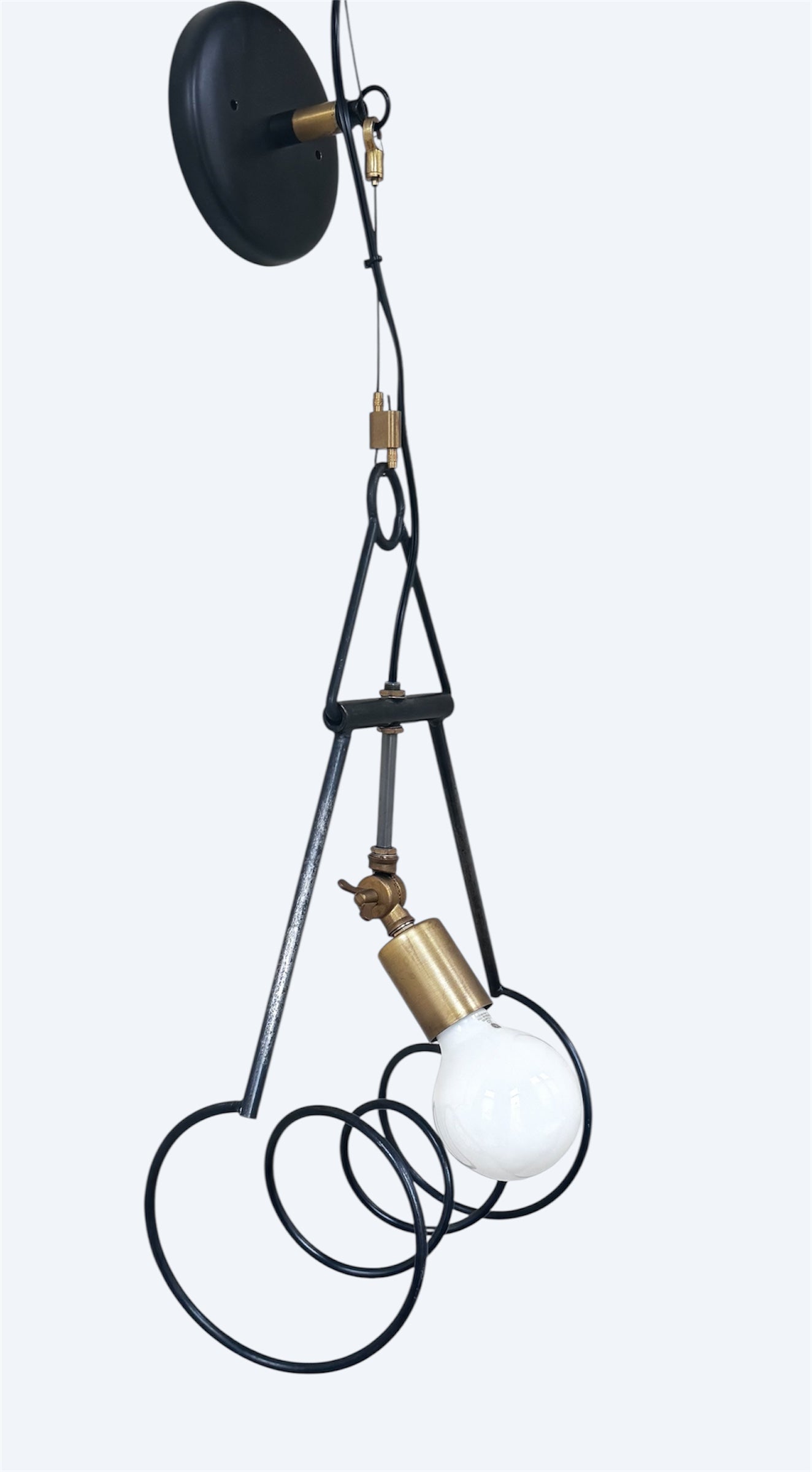 Contemporary steel and brass wall sconce with sculptural design, black powder coat, and clear-coated brass accents.