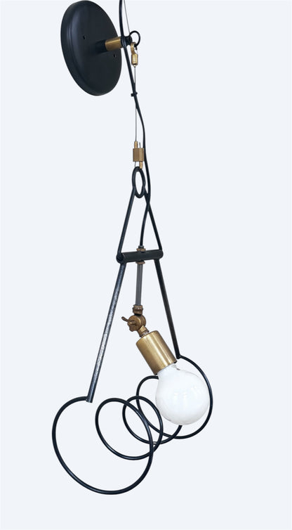 Contemporary steel and brass wall sconce with sculptural design, black powder coat, and clear-coated brass accents.